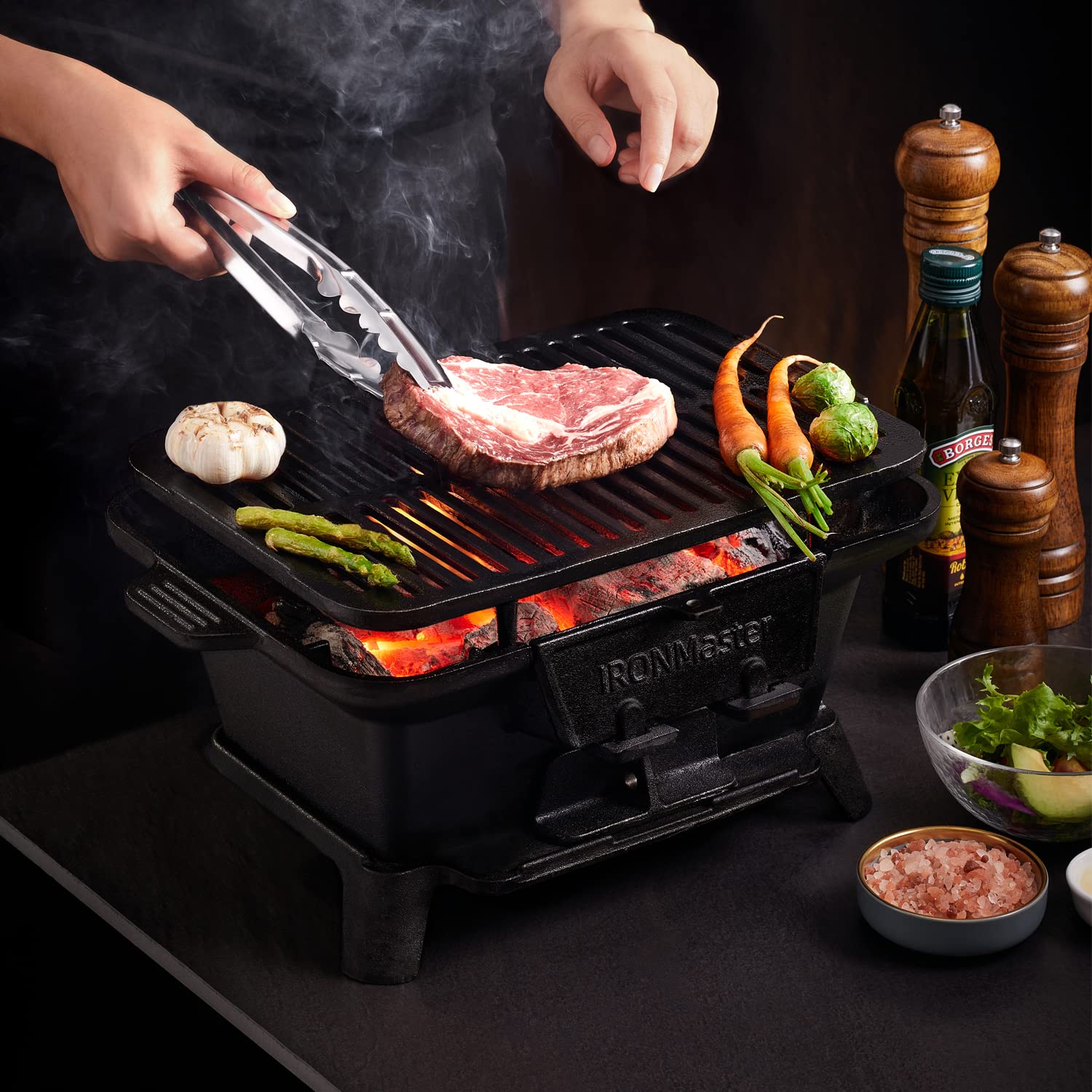 IronMaster Hibachi Grill coal door for quick charcoal reloads.