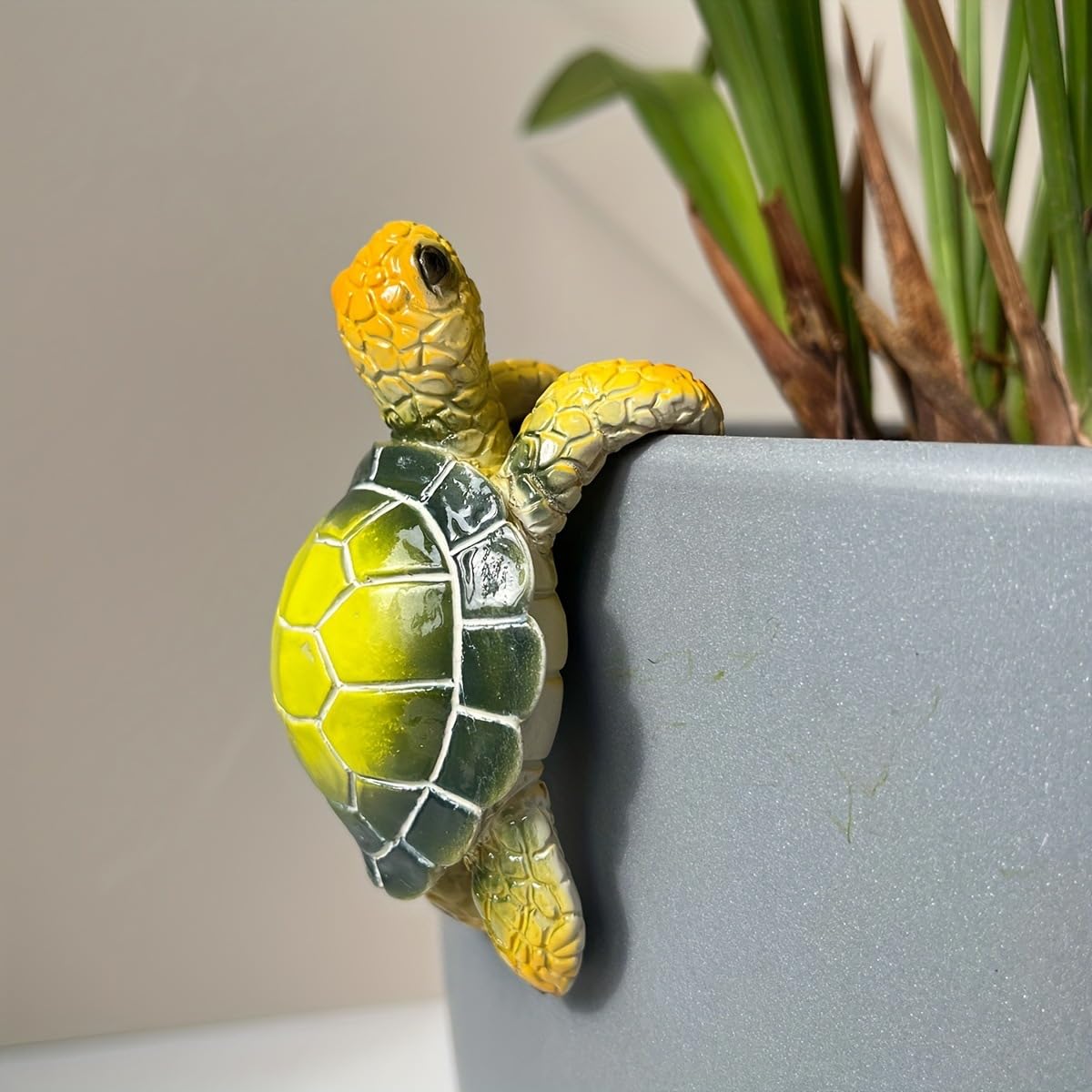 JARPSIRY climbing tortoise statue beside a flower pot for outdoor whimsy