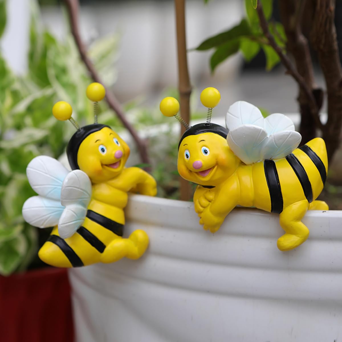 Jarpsiry cute climbing bee perching on planter for whimsical garden charm.