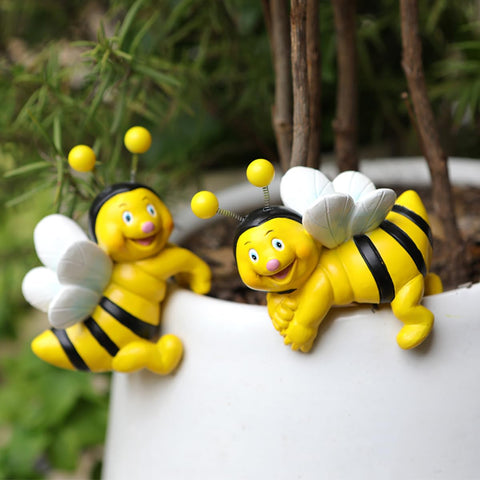 Jarpsiry cute climbing bee perching on planter, brightening outdoor spaces.