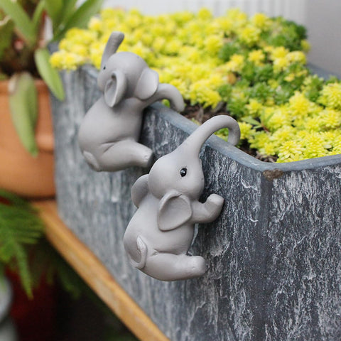 JARPSIRY resin elephants climbing planters add whimsy to outdoor spaces.