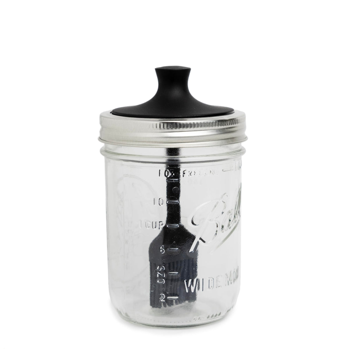 Jarware silicone black basting brush lid on a wide mouth jar for smooth sauce application.