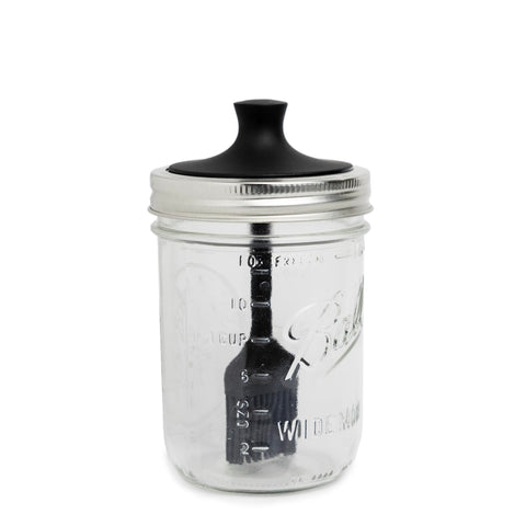 Jarware silicone black basting brush lid on a wide mouth jar for smooth sauce application.