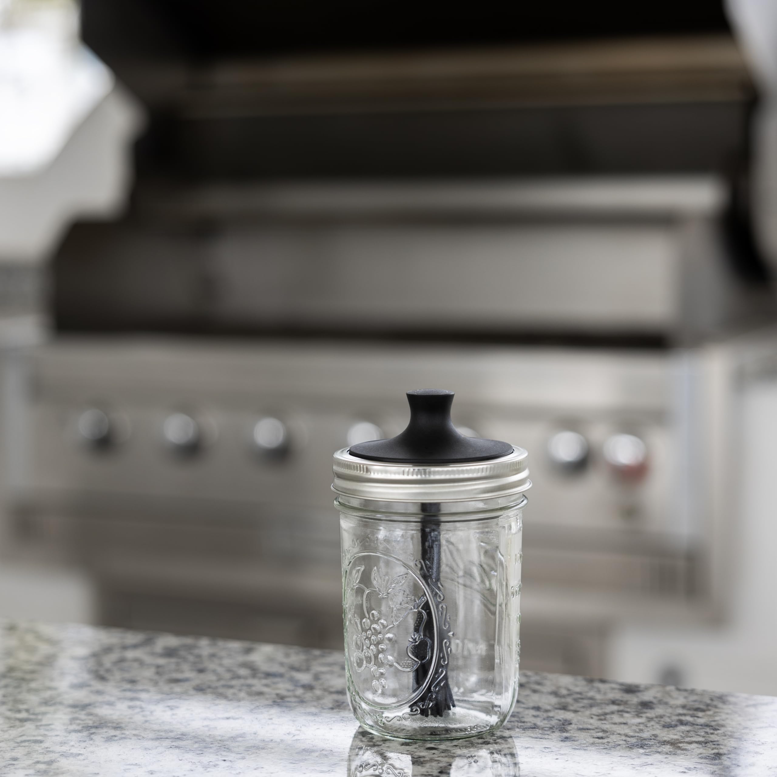 Jarware wide mouth jar lid with silicone bristles spreading marinades evenly.