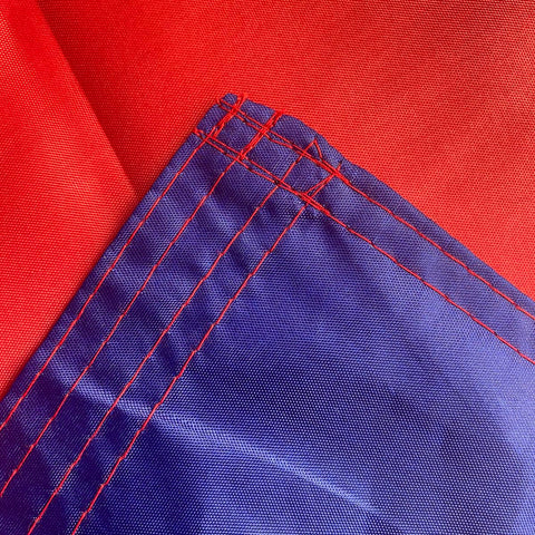 Jayus flag with two brass grommets for secure mounting on any surface.