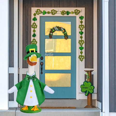 JcHrmers porch decoration shows festive green accents on a lawn goose