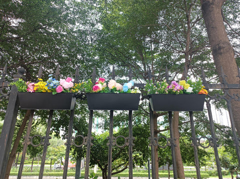 JFMAMJ large railing planter on balcony creates a lush focal point.