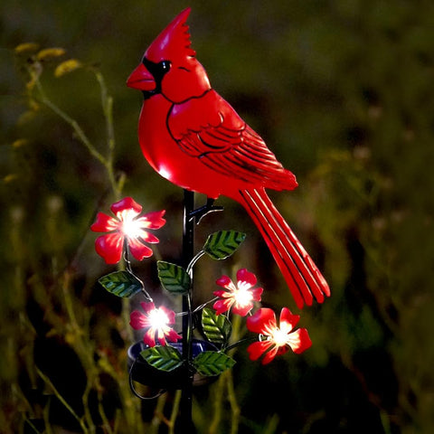 Jiasku cardinal ornament for outdoor decor glows softly after dusk.