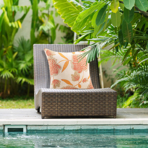 Close-up of JMGBird beige pillow with orange leaves for fall patios.