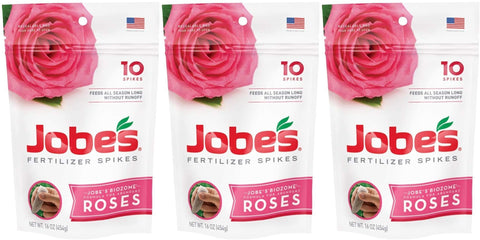 Jobe's Organics Rose Fertilizer Spikes in soil around a rose plant.