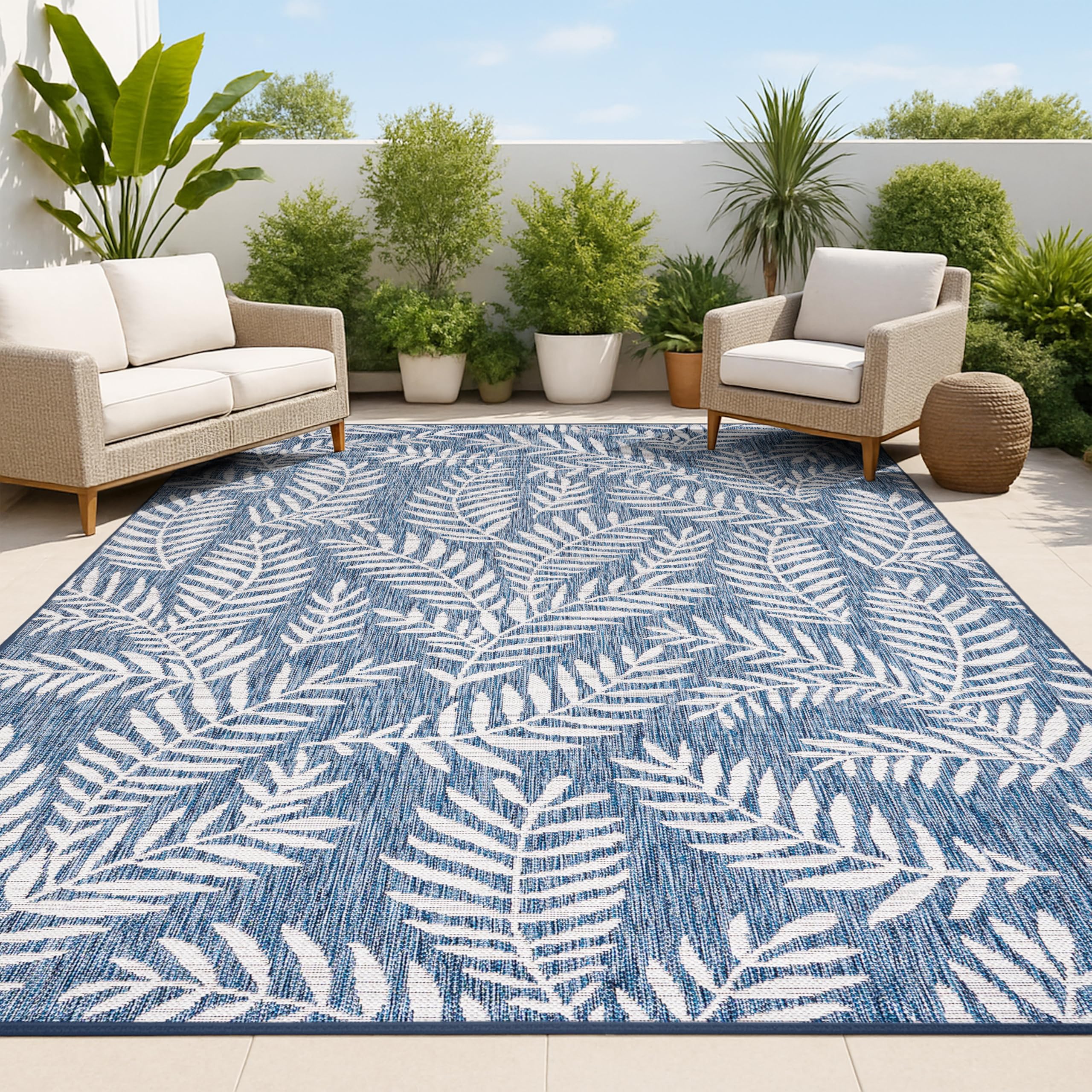 Jonathan Y palm frond rug in navy and ivory for patio ambiance and easy cleaning.