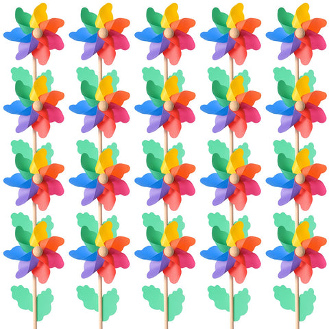 Jucoan rainbow pinwheels in a yard providing vibrant outdoor decor that moves with the breeze