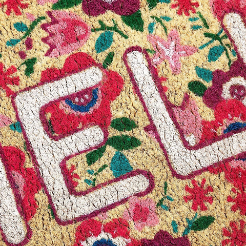 Juvale Secure Backing Coir Doormat Hello design helps stay in place on doorsteps.