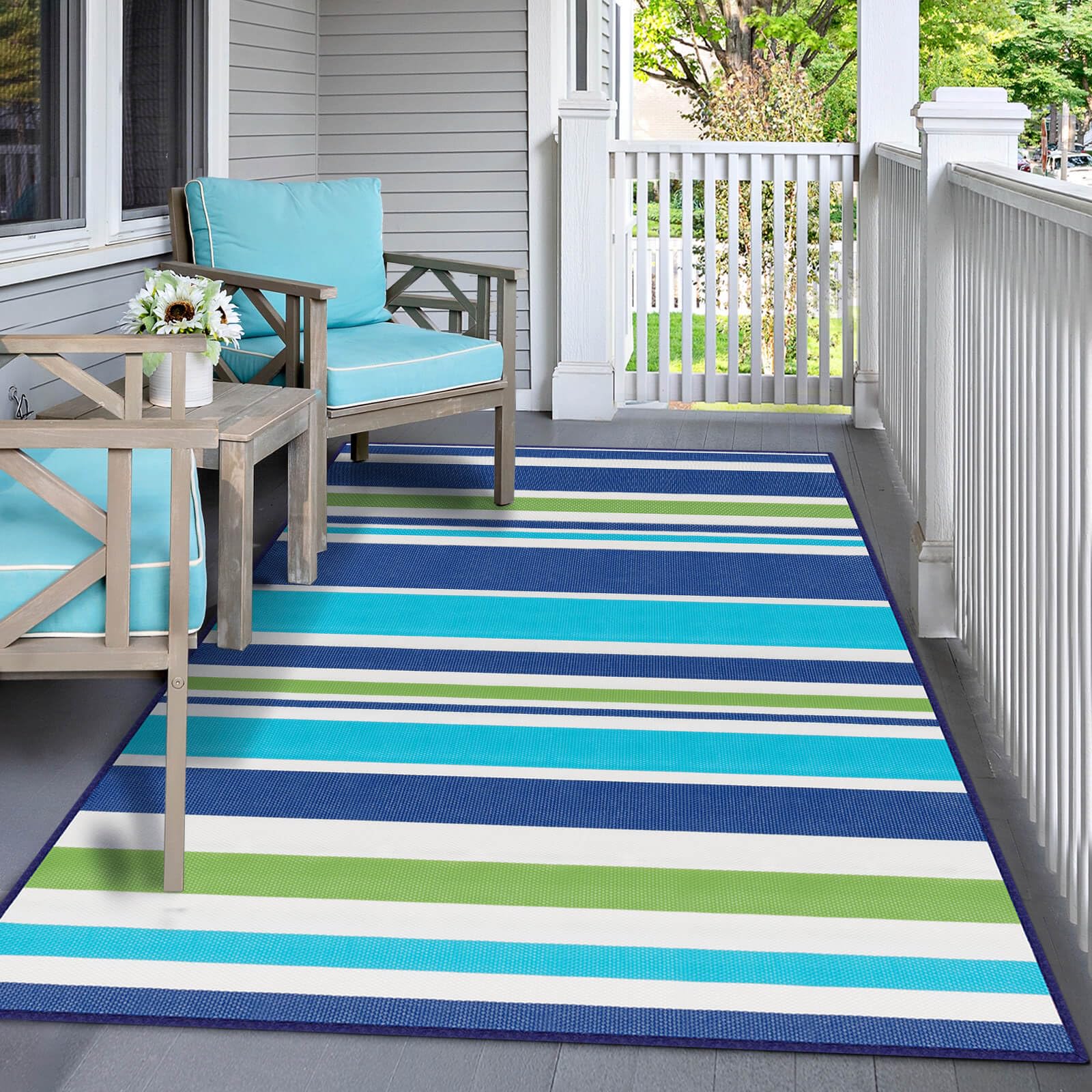 Kalafun rug at beach or campsite, blue-green, ready for easy outdoor setup.