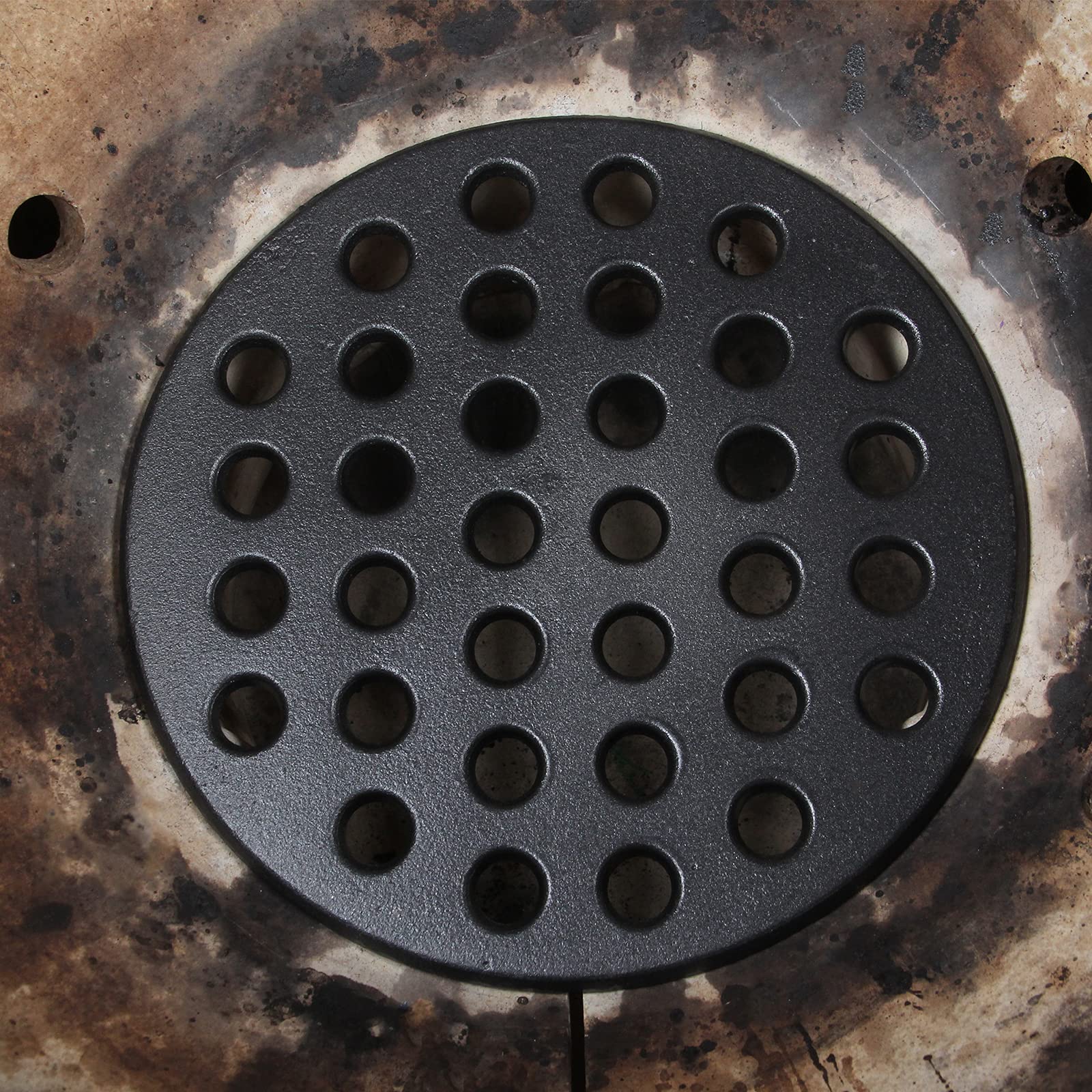 KAMaster 9-inch fire grate provides flat support for charcoal and even flames.