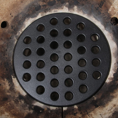 KAMaster 9-inch fire grate provides flat support for charcoal and even flames.