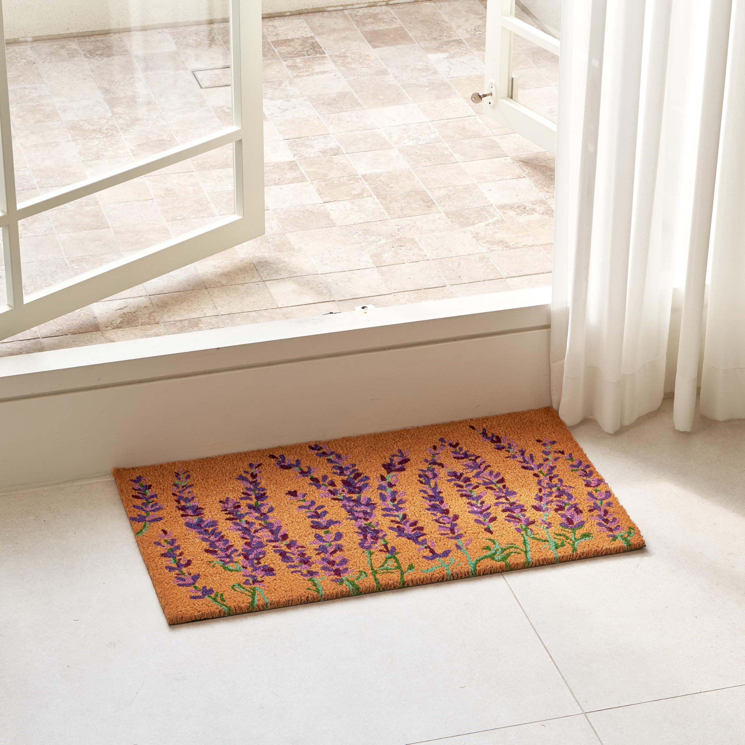 Close-up of KANKUN coco coir bristles scraping dirt at the doorstep.