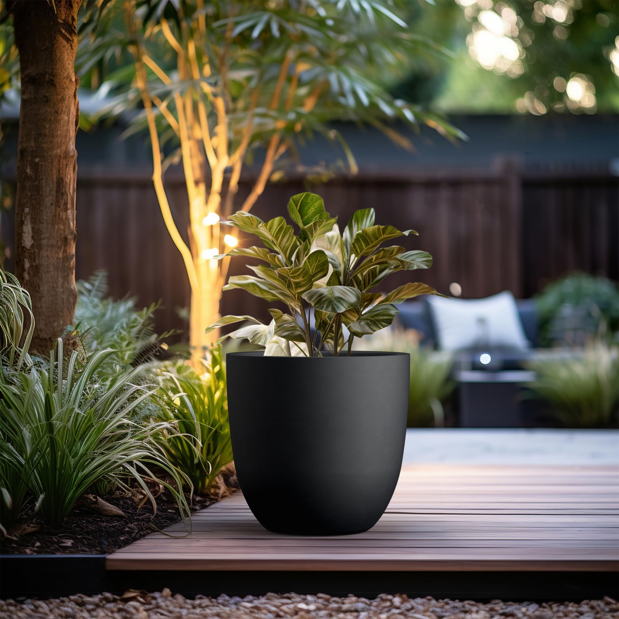 Kante 18-inch round concrete planter drainage hole close-up with rubber plug.