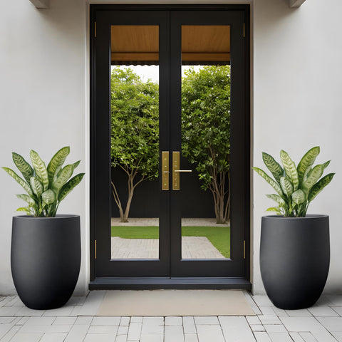 Kante concrete planter with smooth finish complements modern decor on balcony.