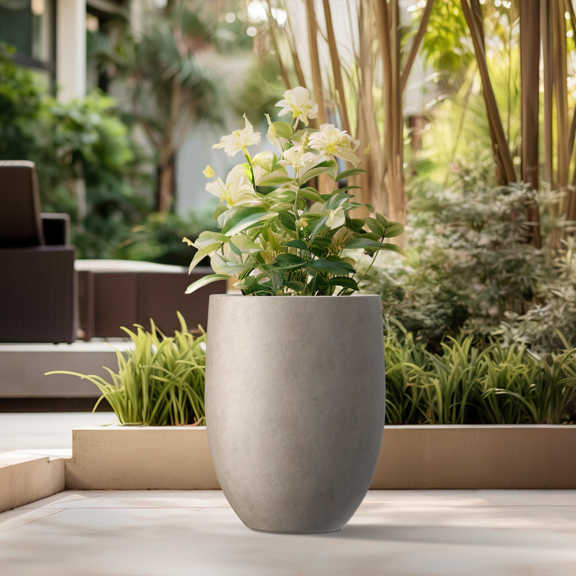 Kante weathered-concrete tall planter shown indoors, complements contemporary interiors.