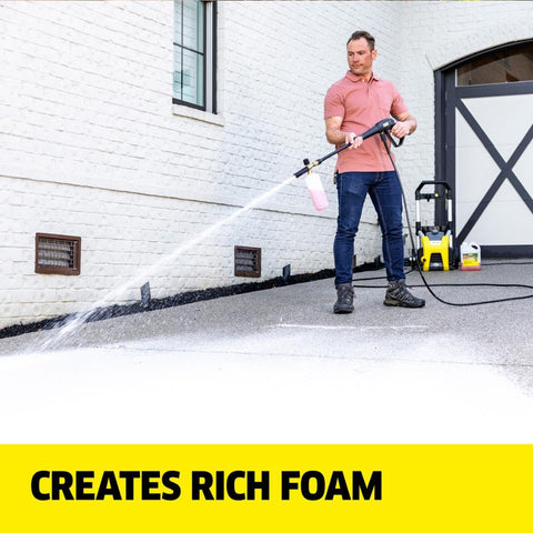 Pressure washer spraying Kärcher cleaner on a driveway for fast dirt removal