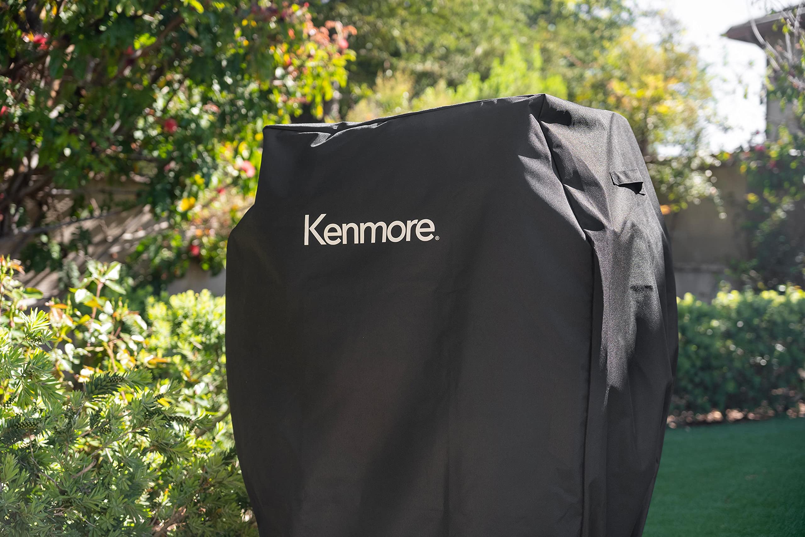 Kenmore 33-inch grill cover universal fit with adjustable straps for secure placement.