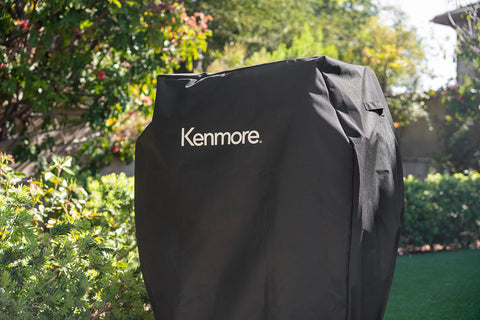Kenmore 33-inch grill cover universal fit with adjustable straps for secure placement.