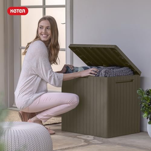 Keter City 30-Gallon storage box storing cushions and garden tools