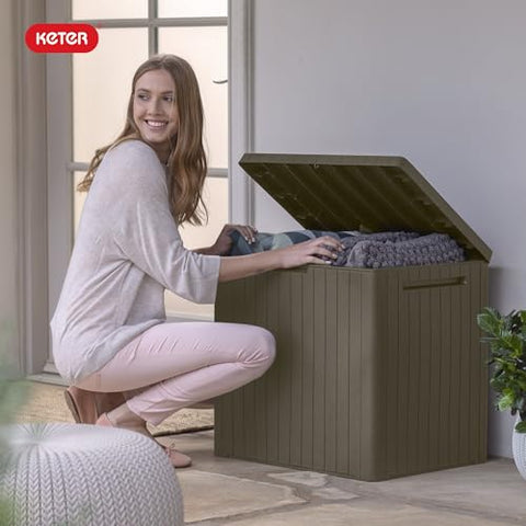 Keter City 30-Gallon storage box storing cushions and garden tools