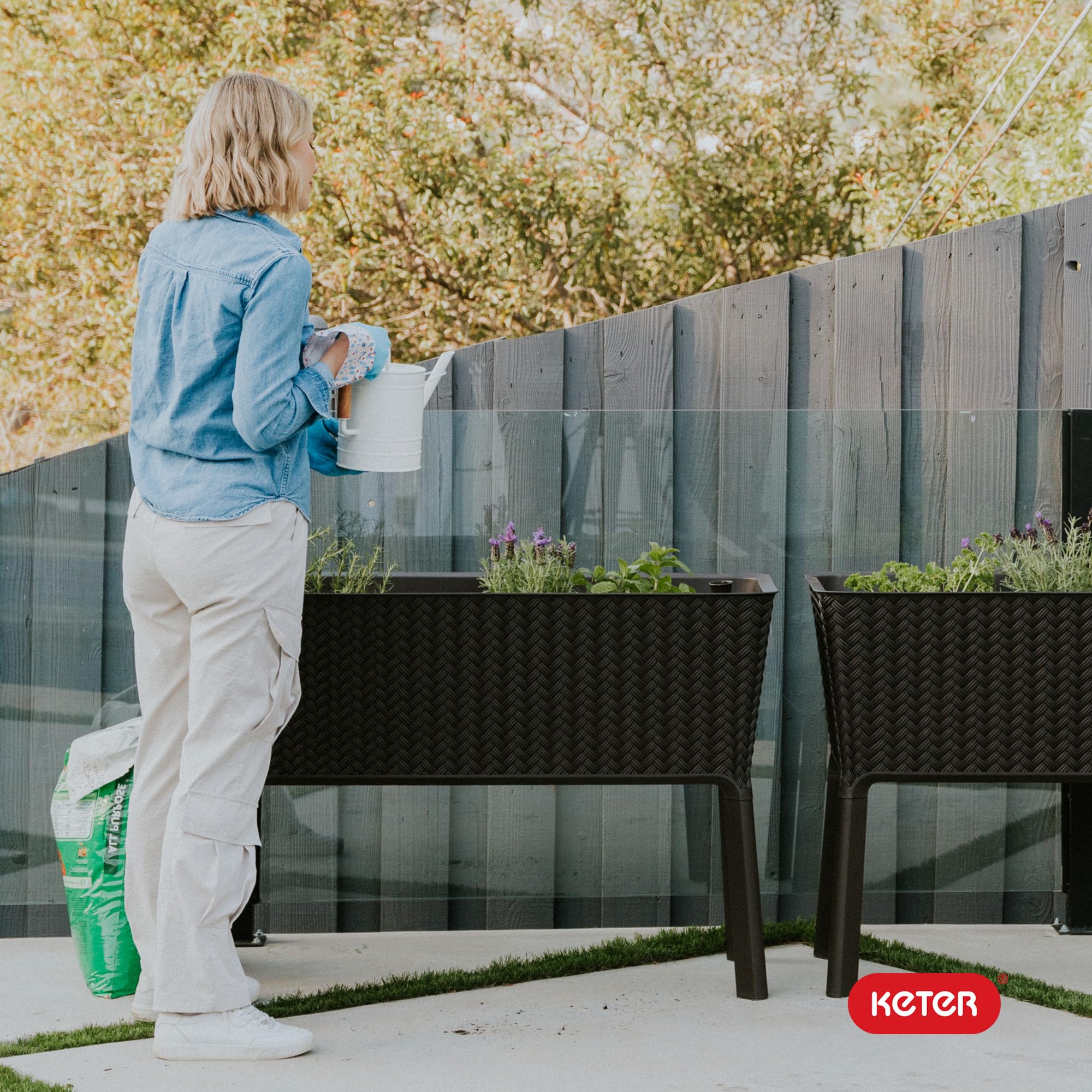 Keter Splendor elevated bed used for vegetables and herbs on balcony.