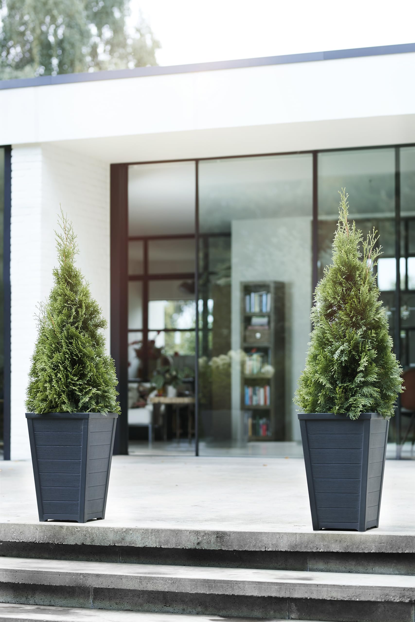 Keter wood-look tapered planter graphite on deck for greenery display.