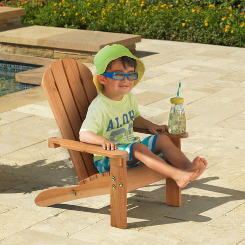KidKraft Adirondack chair honey wood on patio demonstrates sturdy, weather-friendly design for sunny days.