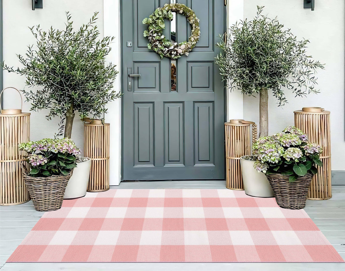 KIhipIoe pink and white buffalo plaid front porch rug enhances curb appeal and durability.