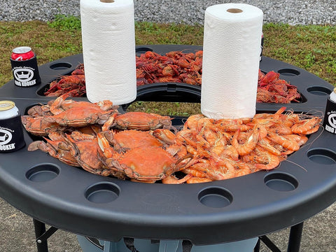 King Kooker table at a tailgate offering ample space for plates and towels.