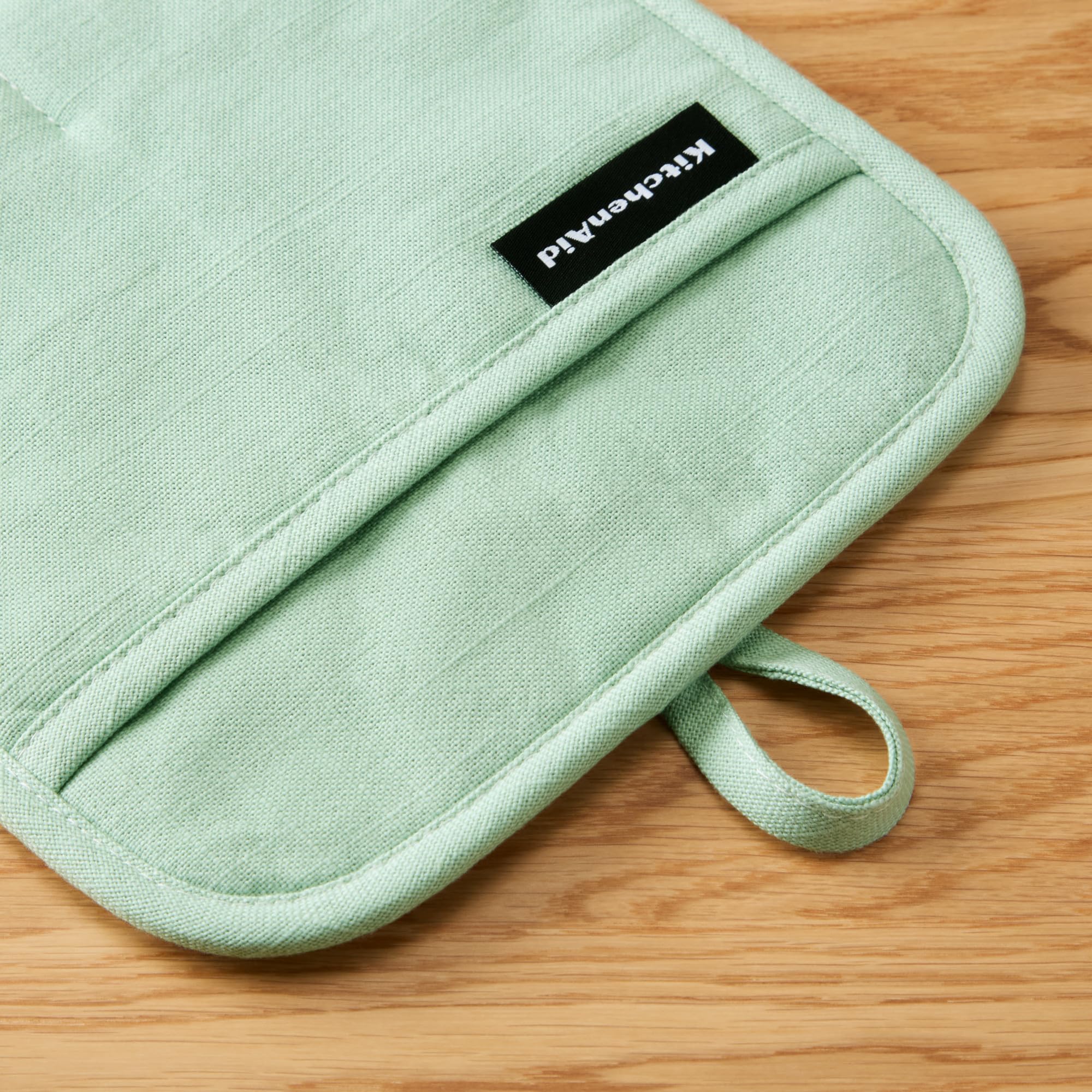KitchenAid Gridlines pot holder resists up to 600°F for oven use.