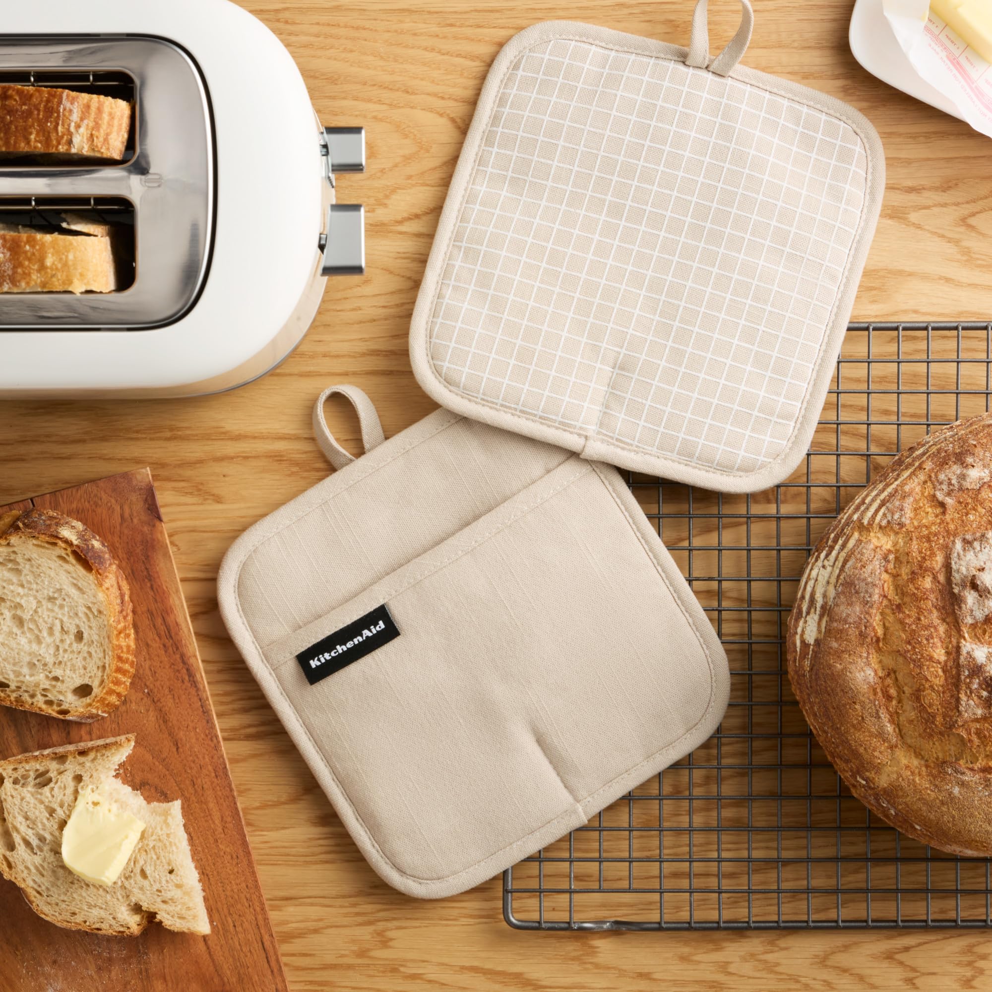 KitchenAid Gridlines pot holder close-up showing slip-resistant silicone grip for secure handling.