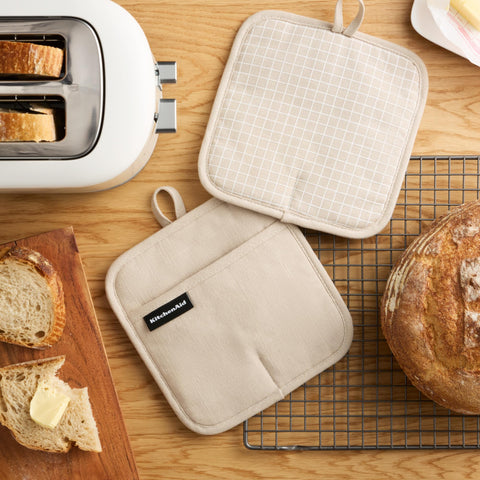 KitchenAid Gridlines pot holder close-up showing slip-resistant silicone grip for secure handling.