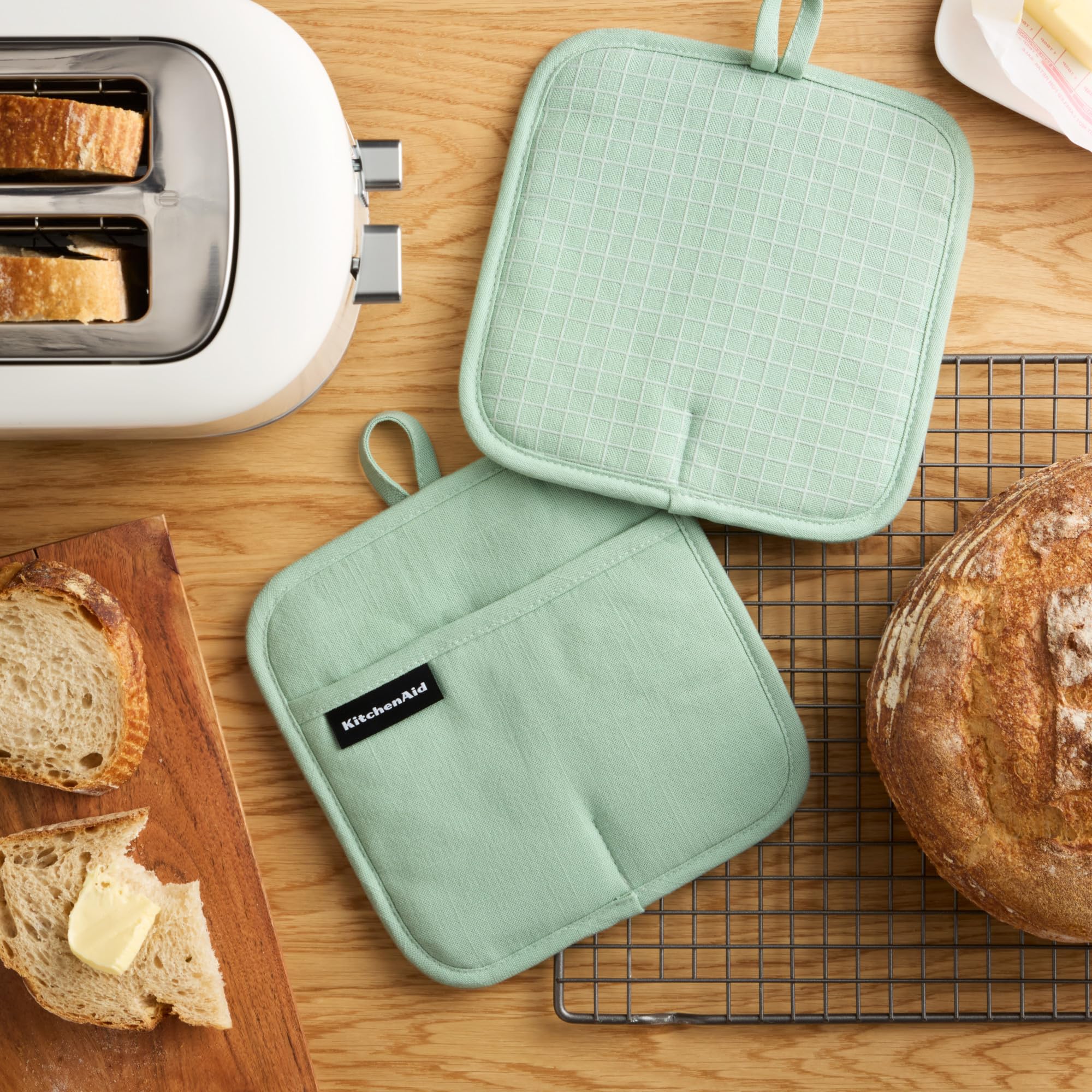 KitchenAid Gridlines silicone palm grip provides slip-resistant control for hot cookware.
