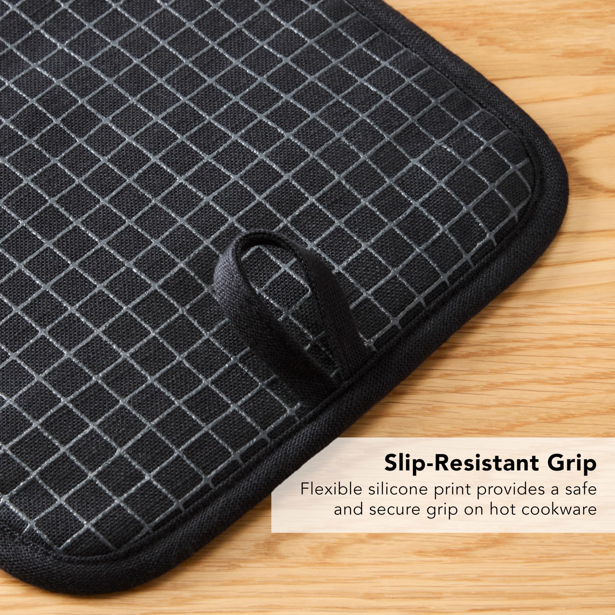 KitchenAid potholder in use lifting a hot pan with a safe grip.