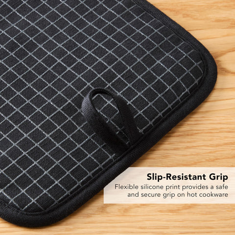 KitchenAid potholder in use lifting a hot pan with a safe grip.