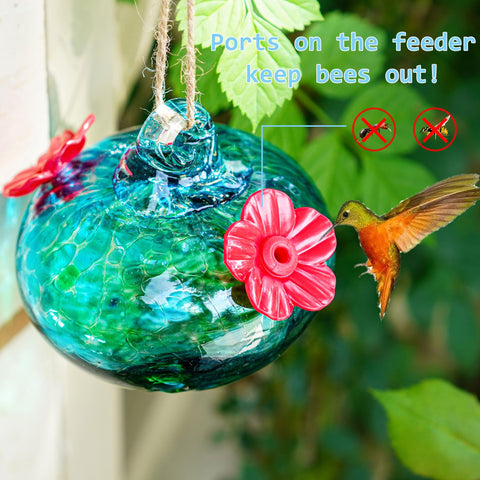 KRISININE glass hummingbird feeder used as outdoor garden decor