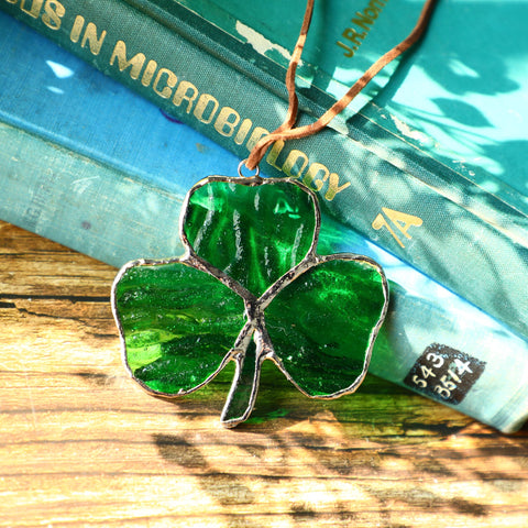 KRISININE stained-glass shamrock panel catching sunshine to create rainbows.