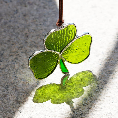 KRISININE shamrock suncatcher reflects sunlight to brighten interiors with color.
