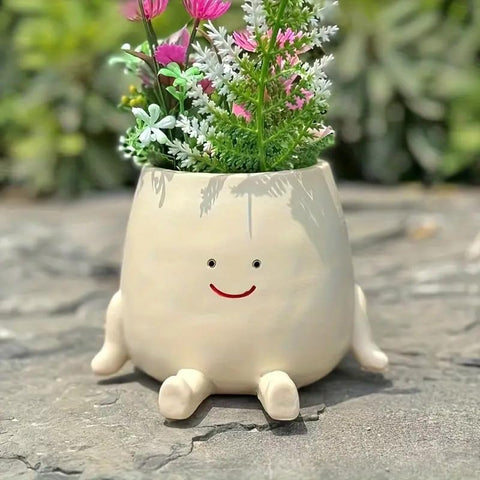 Kudriod Smiley Face Planter on outdoor patio with greenery for outdoor decor