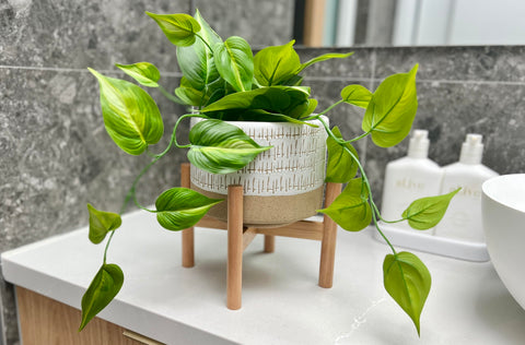 Kurrajong Farmhouse planter with bamboo stand complements a bathroom decor setup.