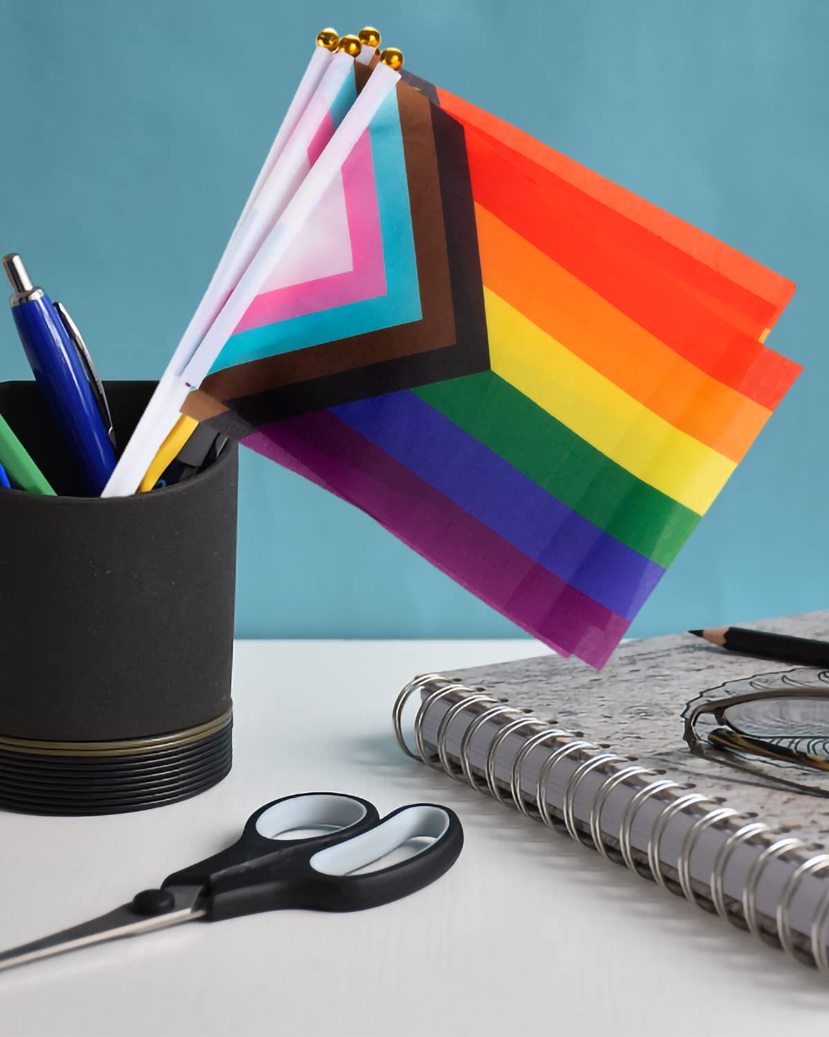Labeol rainbow flags outdoors with colorfast inks resisting sun and wind.
