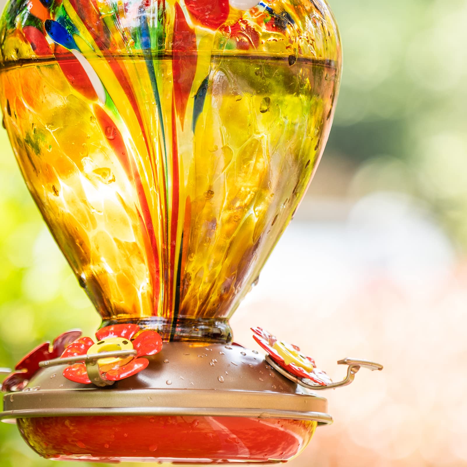 LaElvish Garden hummingbird feeder blue glass close-up adds vibrant color to outdoor decor.