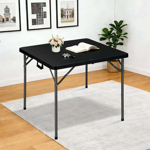 Lakhow folding table with collapsible legs being set up for seating.