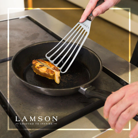 Lamson spatula in action on grill, great for lifting burgers and fish.