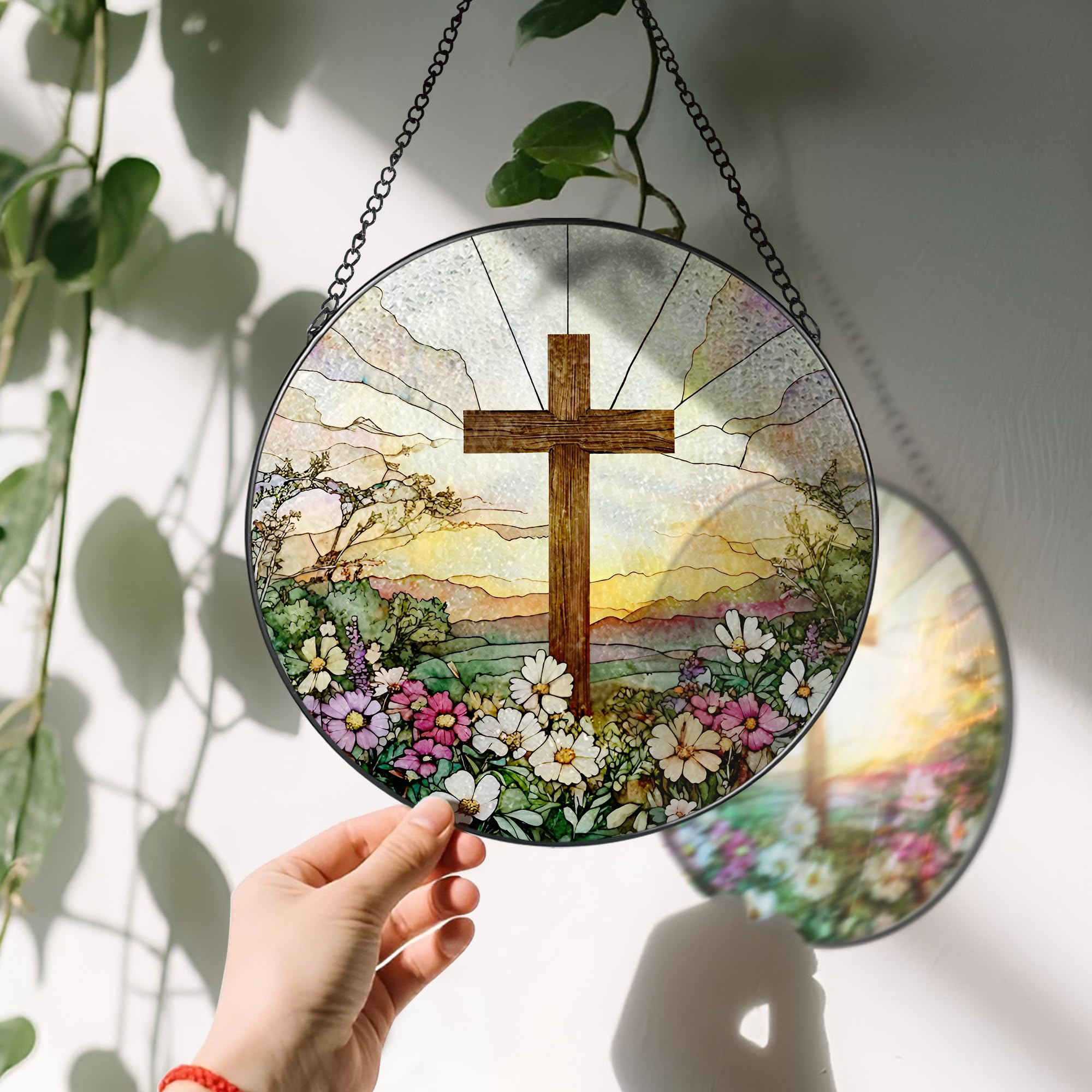 LAOWEIKI cross suncatcher framed in black metal for easy hanging.
